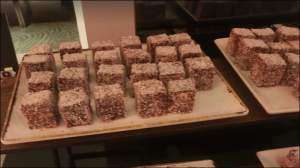 Cubes of chocolate and coconut-coated treats arranged neatly on a serving platter.